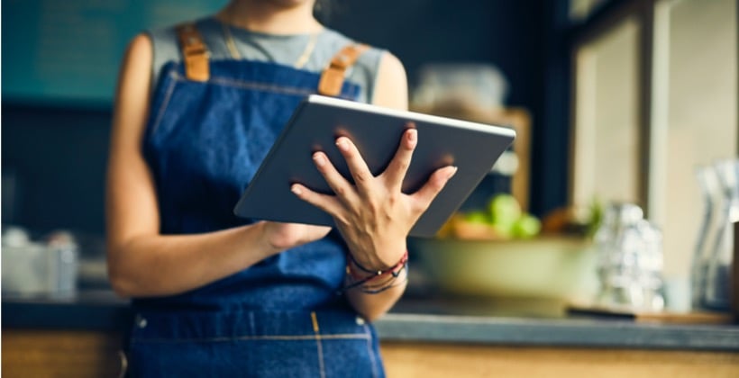 midsection-of-female-barista-using-digital-tablet-picture-id579400372-2