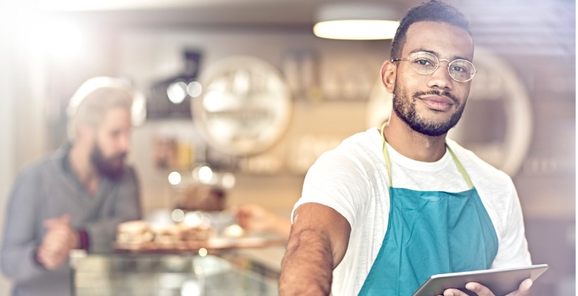 portrait-of-smiling-owner-standing-in-her-coffee-shop-picture-id619406376-2