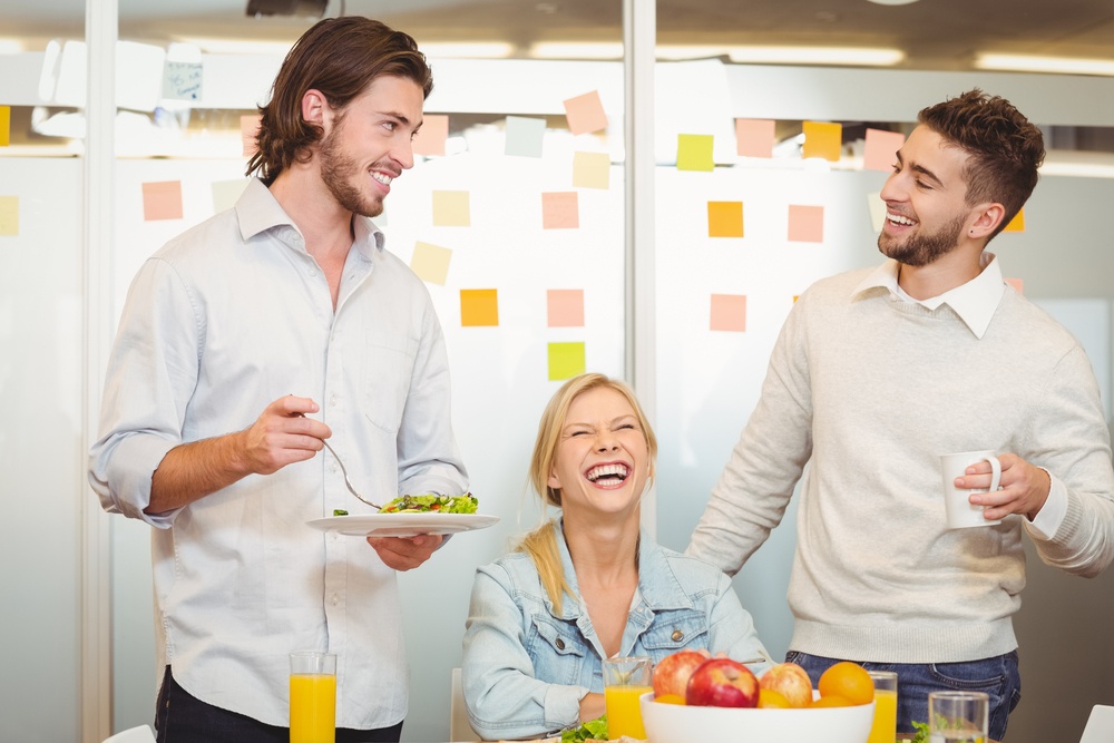 Employees having fun during breakfast in creative office.jpeg