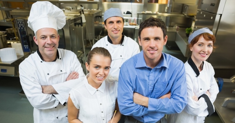 Handsome manager posing with some chefs and waitress in a kitchen-230475-edited.jpeg
